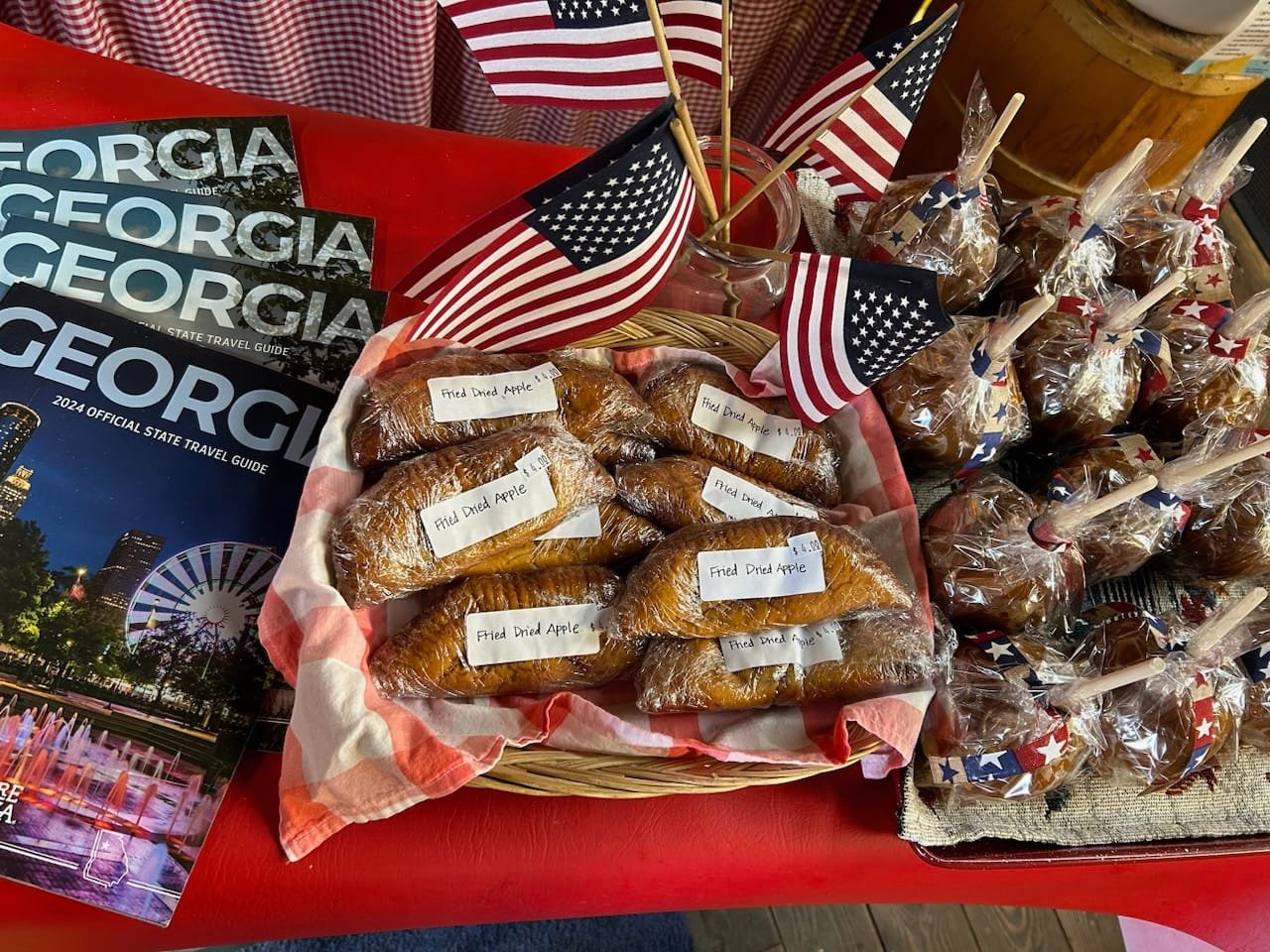 A basket of fried dried apple pies with American flags on display at Fred's Famous Peanuts